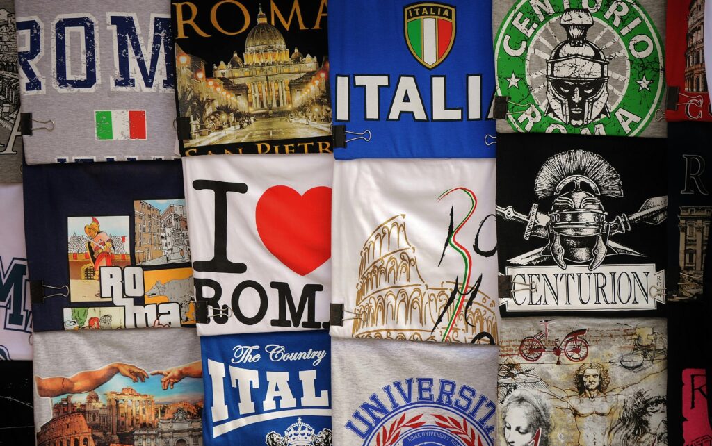 A vibrant assortment of Italian-themed graphic T-shirts showcasing classic designs and iconic landmarks.