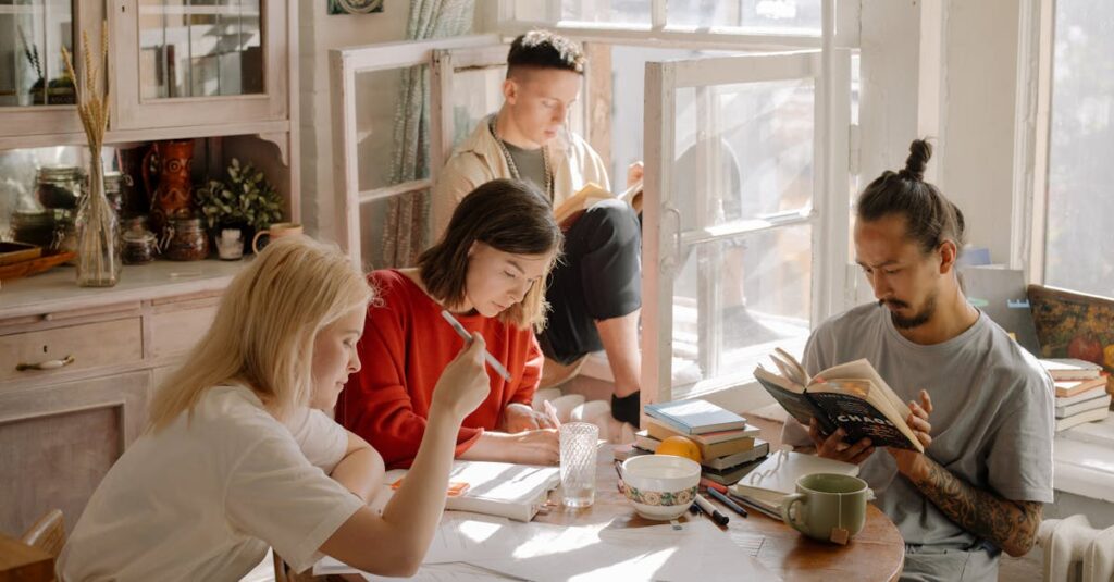 A group of college students studying in a bright, cozy room with natural light.